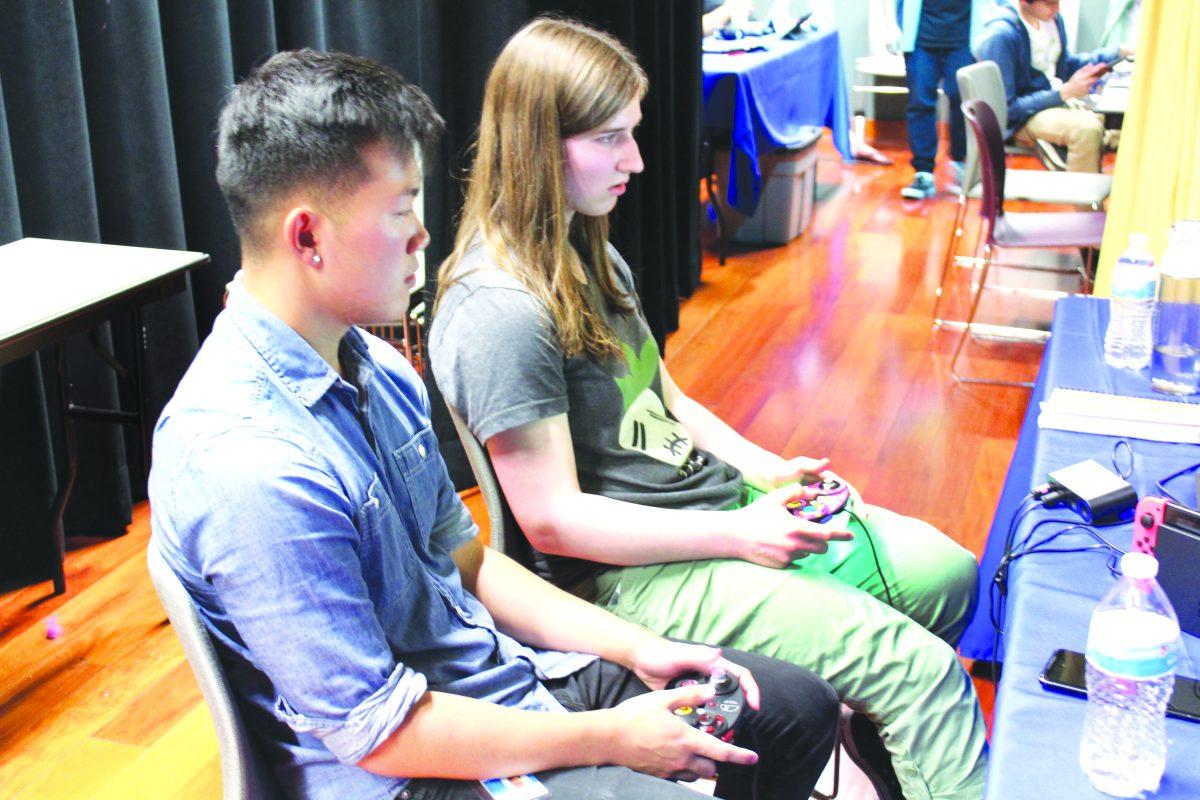 Cognitive science junior David Eloey (left) and animation and illustration sophomore Claire Kerr (right) battle in the final match of the Super Smash Bros. Ultimate tournament. / Chris Core