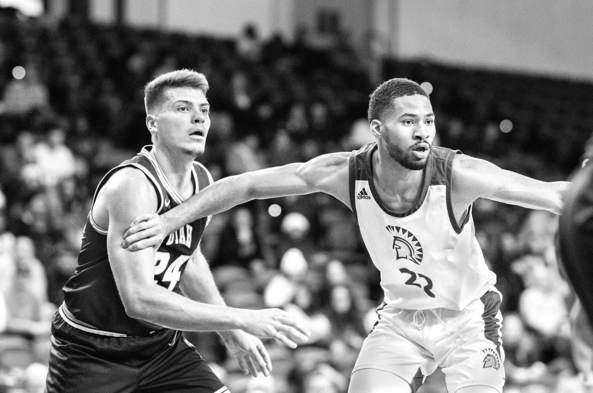 Junior guard Richard Washington defends senior Utah State guard Diogo Brito, but the  Spartans eventually fell to the Aggies 71-59. Photo by Blue Nguyen.
