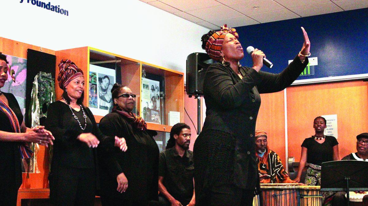 Tabia ensemble member Sharon Moore recites a spoken verse to spectators during the opening of the Tabia 35th anniversary exhibition,  at the Dr. Martin Luther King Jr. Library on Saturday.