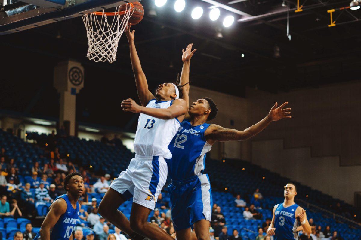Sophomore guard Seneca Knight drives to the basket against Air Force senior foward Lavelle Scottie to get two of the 20 points he scored on Saturday. Jesus Tellitud | Spartan Daily