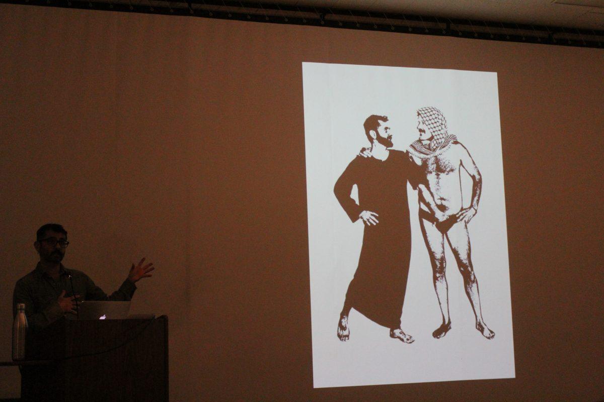 Visual artist Jamil Hellu explains the depiction of queer sexuality, cultural identity and masculinity among gay men in his art work during his lecture on Tuesday. Paul Hang | Spartan Daily