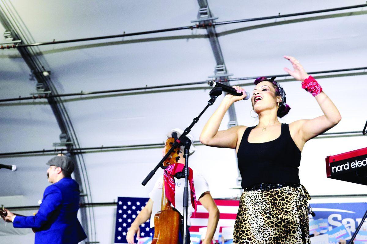 Las Cafeteras main vocalist Denise Carlos sings infront of a lively crowd at the Bernie Sanders rally Sunday afternoon. Photo by Mauricio La Plante