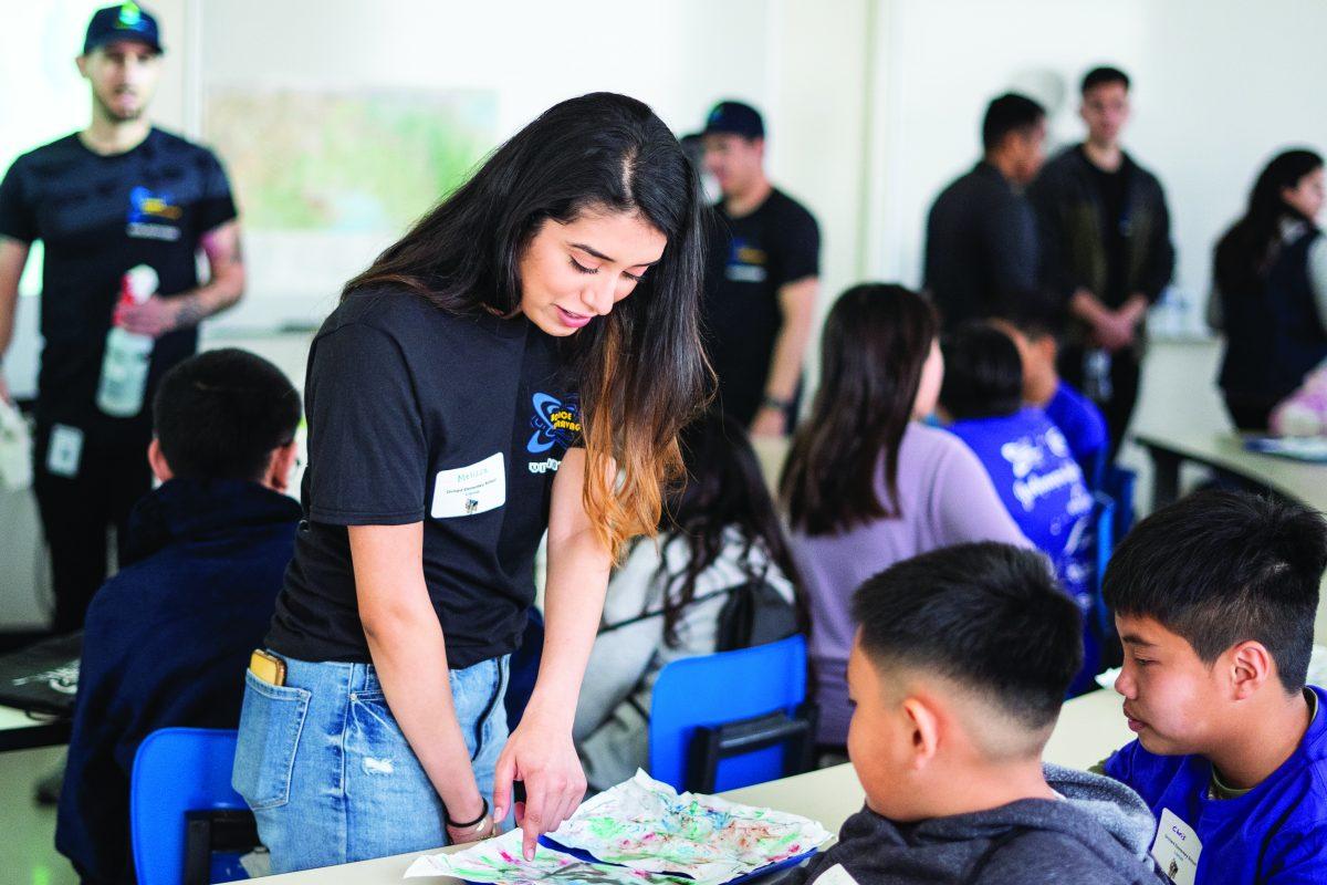 Biomedical engineering junior Melissa Ortiz talks to kids about immigration at the Science Extravaganza event in the Student Union Saturday morning. Jesus Tellitud/Spartan Daily