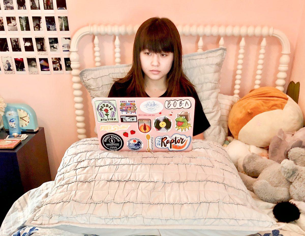 Ayla Fung, a tenth grader, works on her computer to complete a homework assignment for her online class. Courtesy of Jonathan Fung