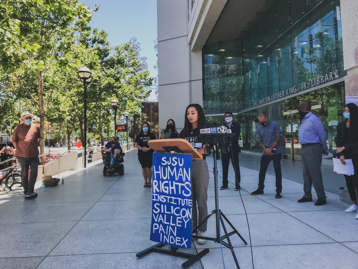 Sociology senior and Student Homeless Alliance president Briena Brown (center) was one of three students who announced the release of 65 new Santa Clara County statistics by Dr. Martin Luther King Jr. Library Tuesday. Erica Lizarrago/Spartan Daily