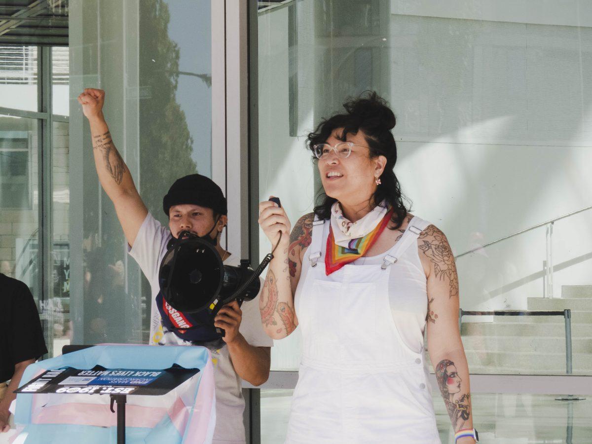 Emcee Sera Fernando leads the group of protesters in a series of chants remembering Black transgender people who died during an event outside City Hall Saturday. Christian Trujano/Spartan Daily