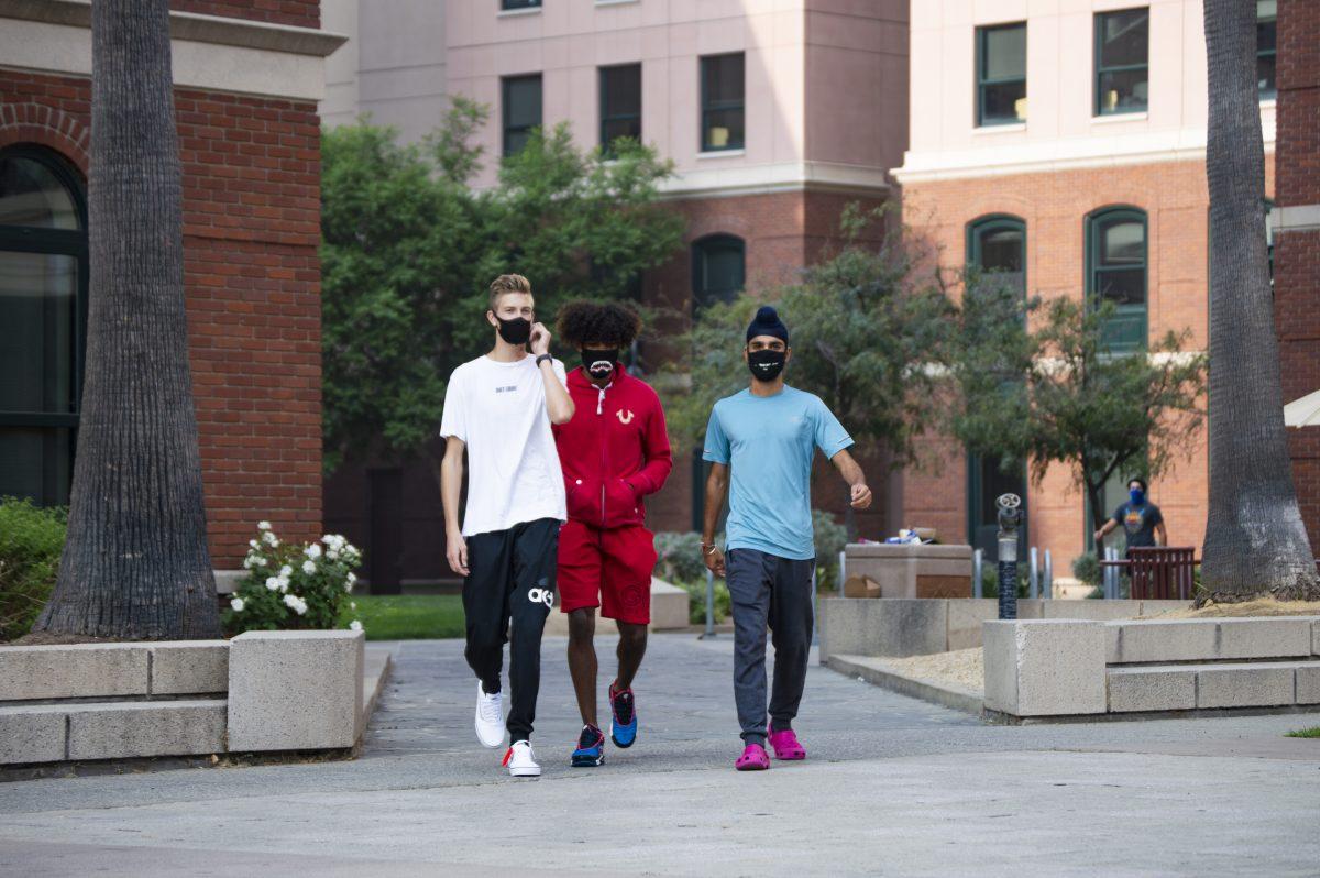 From left to right: Tyler Cash, a justice studies freshman, Christian Rodriguez, a sociology freshman and Gulabjeet Singh, a business freshman, wear masks on their way to the Dining Commons on Monday. | Photo by Blue Nguyen