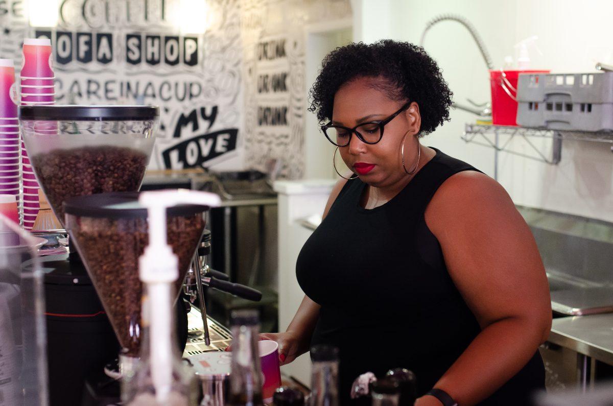 Co-founder of Nirvana Soul, Jeronica Macey, makes coffee behind the bar of the cafe at 315 S. 1st St.