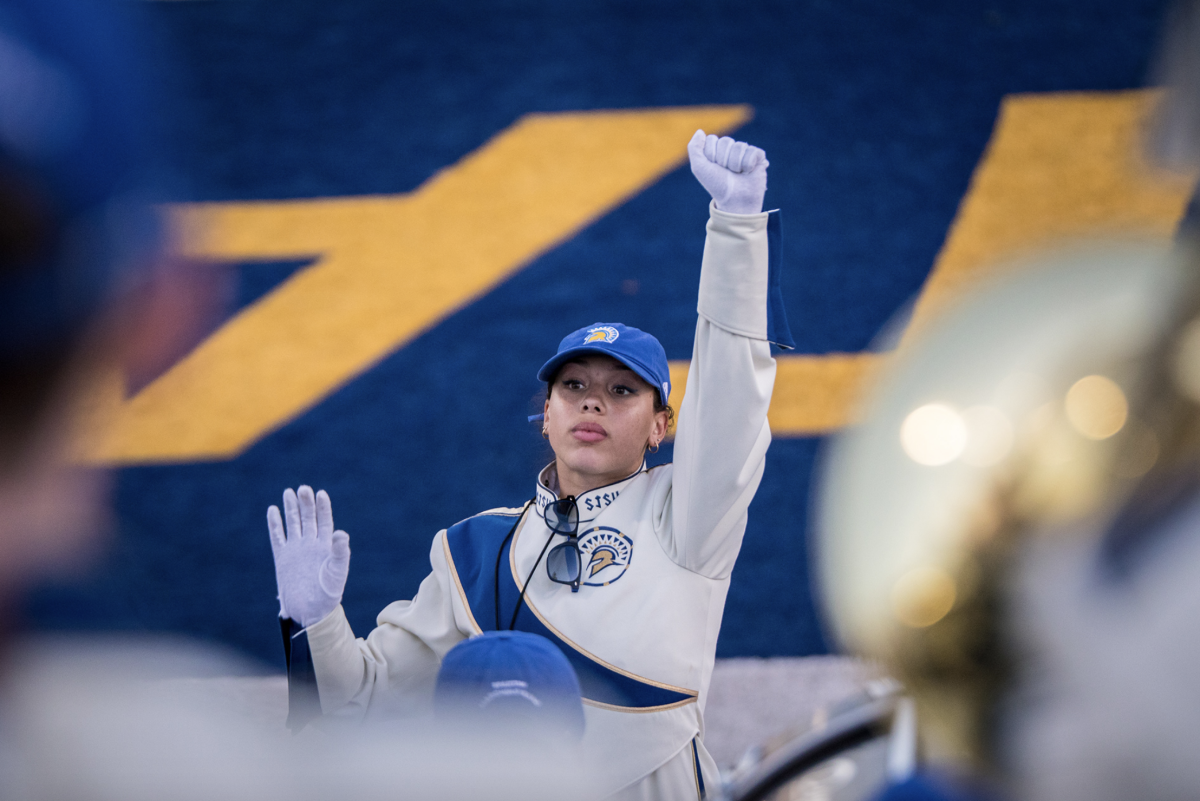 Photo courtesy of Joseph Khalifa. Jazmin Mack, SJSU marching band&#8217;s co-drum major and a chemistry senior, conducts the Spartan Marching and during a home football game against UNC on Aug. 30, 2019.