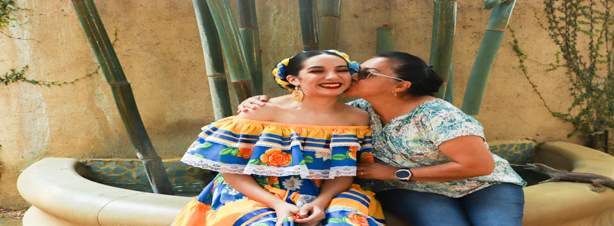 Guadalupe Alvarez, una bailarina de folklorico, muestra affecto a Zuleima, su hija y estudiante de baile de tercer ano de la Universidad Estatal de San Jose, en su traje de folklorico