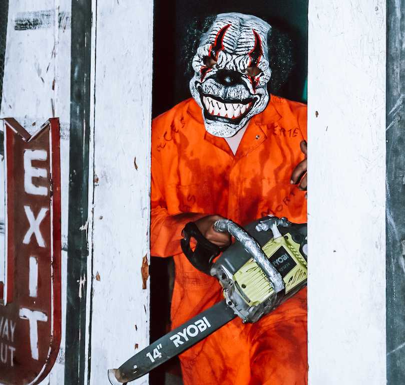 Spyder the clown, a fright walk character, waits for haunt attendees at the end of a maze. Photo by Jovanna Olivares.