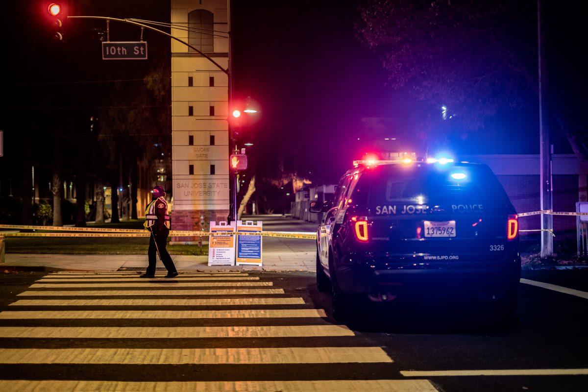 A San Jose police officer directs traffic near San Jose State as police close off East San Fernando and South 10th streets after reports of a mass stabbing Sunday. Jesus Tellitud | Spartan Daily