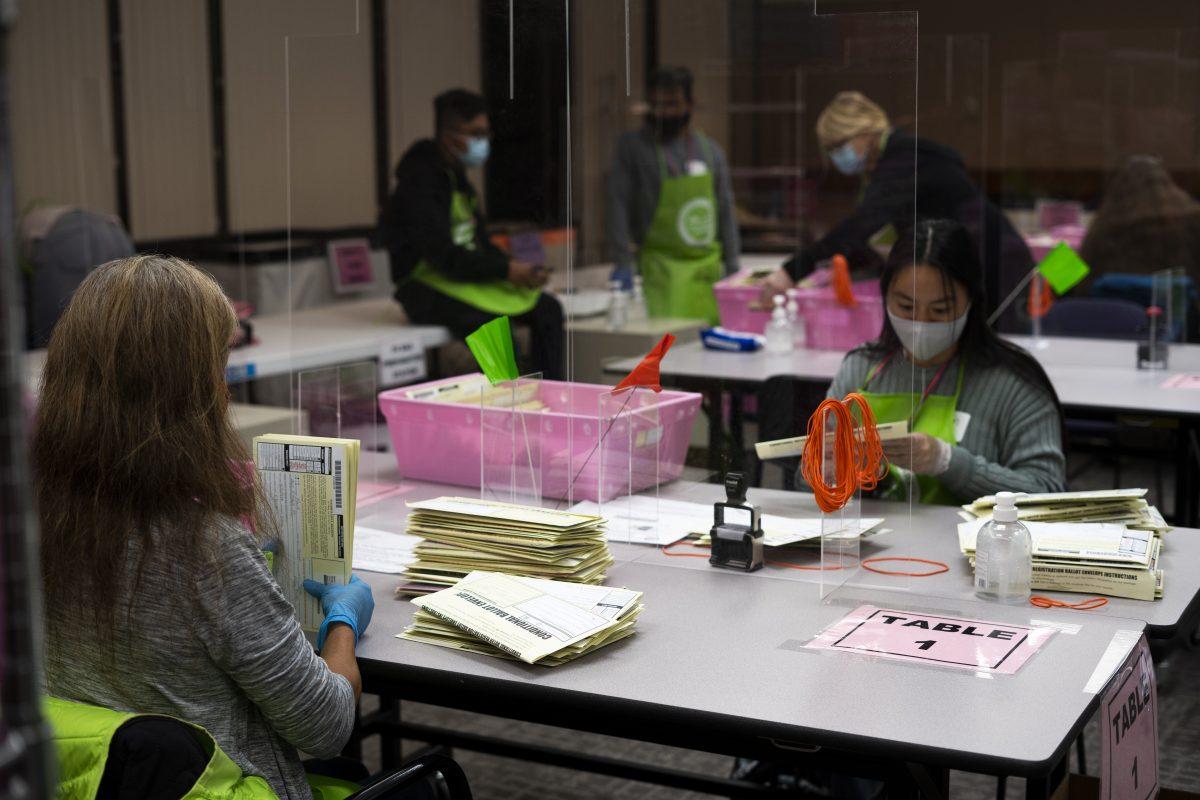 Multiple Santa Clara County Registrar of Voters volunteers and workers count provisional ballots Tuesday night at the Santa Clara County Registar of Voters Office. Jesus Tellitud/ Spartan Daily.