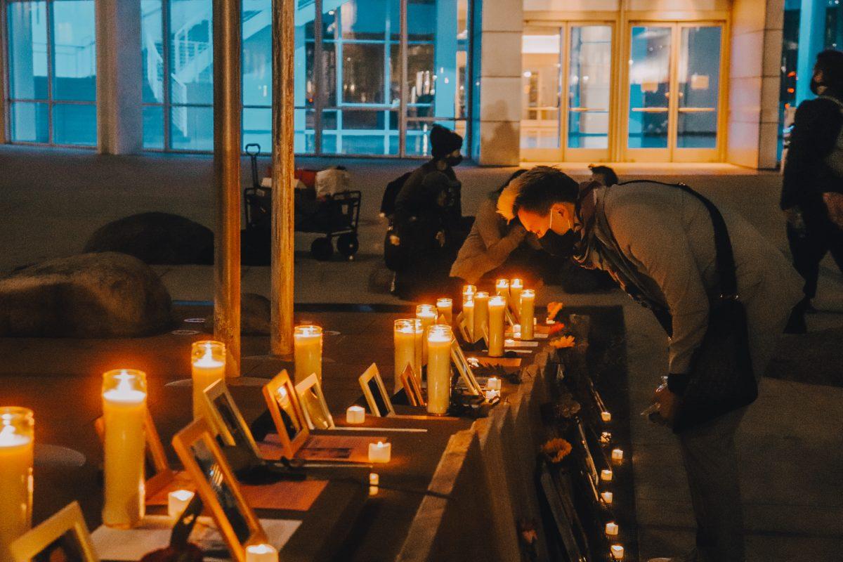 Hieu Samuel Nguyen brings flowers to a memorial for the victims of transphobic hate crimes on Transgender Day of Remembrance. Photo by Jovanna Olivares.