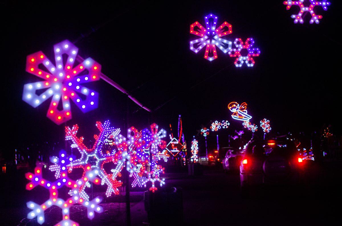 Cars cruise through Christmas in the Park&#8217;s reimagined drive-through experience at its new location at History Park on Senter Road near CEFCU Stadium. Blue Nguyen | Spartan daily 