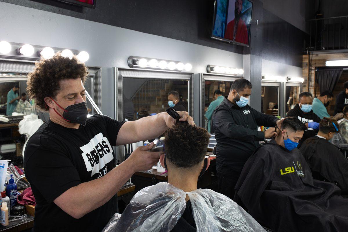 Owner of Barbers Inc, Dave Diggs cuts a client&#8217;s hair at his barbershop on East Santa Clara steet on Friday. Yann Lapnet | Spartan Daily
