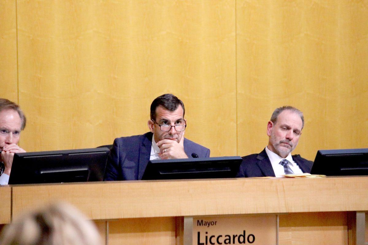 San Jose City Attorney Rick Doyle (left), Mayor Sam Liccardo (center) and City Manager Dave Sykes (right) listen to public comment in a November 2018 city council meeting.