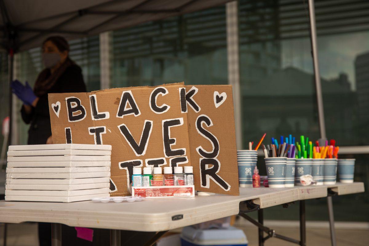 A Black Lives Matter sign sits with art supplies on Black Liberation and Collective Knowledge (B.L.A.C.K.) Outreach's table during a demonstration at San Jose City Hall Monday