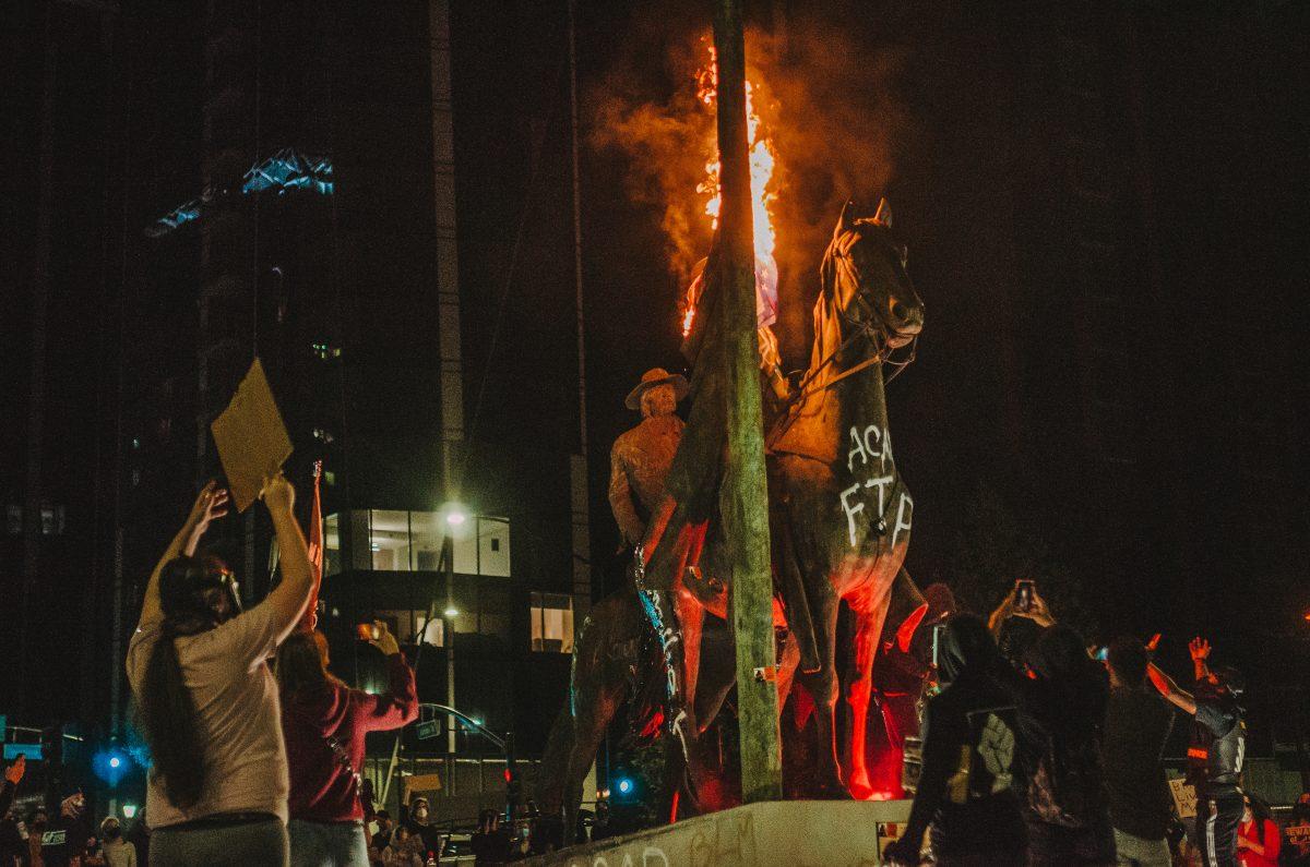 Protesters set fire to the Thomas Fallon Statue on West Julian and St. James streets during a protest downtown on Sept. 23