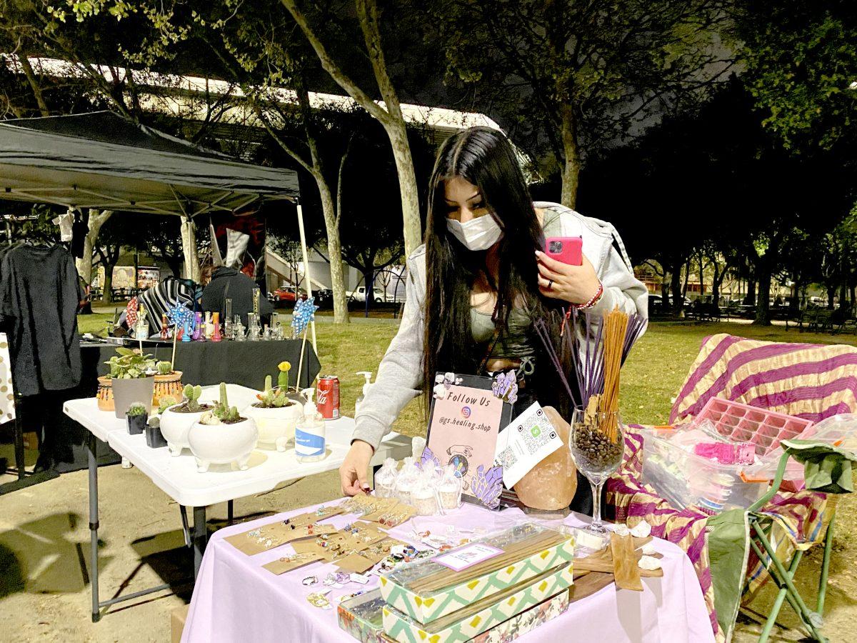Gabby, who prefers to go by her first name, sells her products from her buisness G Healing Shop at the PUblic Spark Rally in front of the SAP Center in Downtown San Jose Tuesday night
