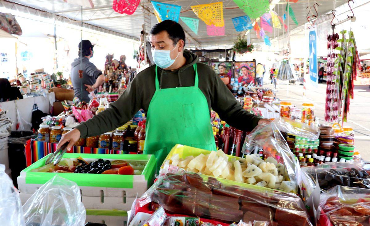 Tony Gonzalez, a vendor separates Mexican Fruit dried candy into bags on March 19 at his stand at the San Jose Flea Market in Berryessa I Photo by Jovanna Olivares