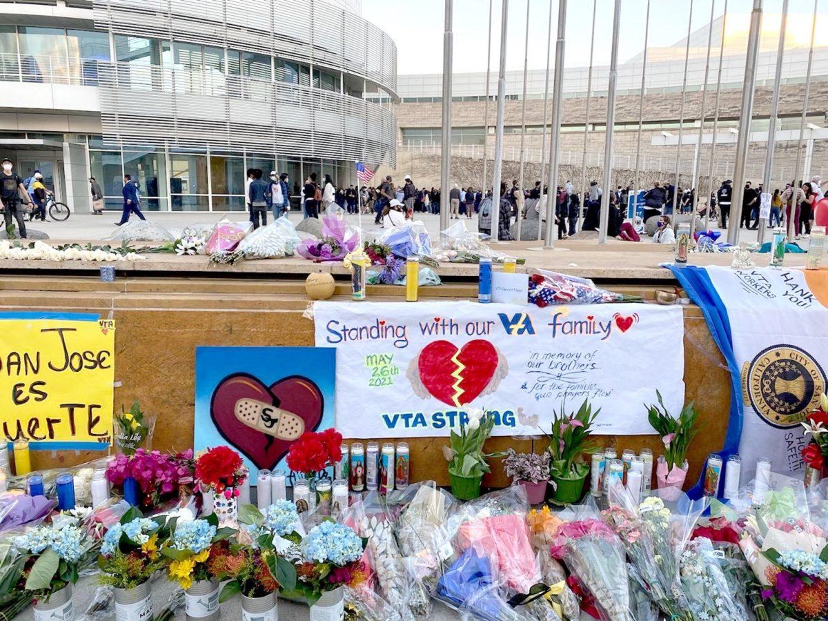 Flowers, candles and signs are placed in front of San Jose City Hall on Thursday in memory of nine VTA employees who died after a coworker opened fire at a San Jose rail yard Wednesday. Photo by Madilynne Medina