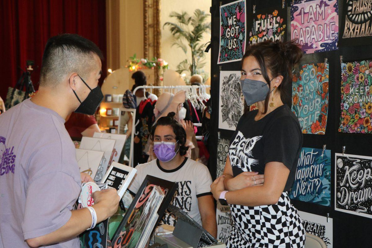 Redwood City resident Jonas Sung (left) talks to artist Alyssa Wigant by her booth. Wigant hand-letters her artwork and also created a zine of more than 10 pages that were offered to the first 500 attendees on Saturday and Sunday respectively.