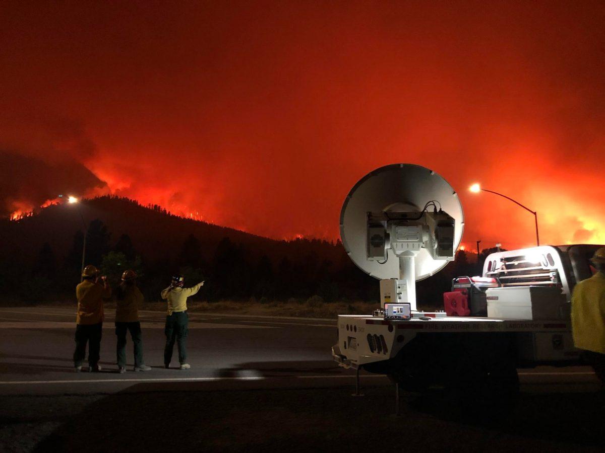 Justin Haw (left), Kiera Malarkey (center) and Kate Forrest, graduate students with SJSU's Wildfire Interdisciplinary Research Center, observe the Dixie Fire in the summer of 2021 in Milford, California. Photo courtesy of Craig Clements
