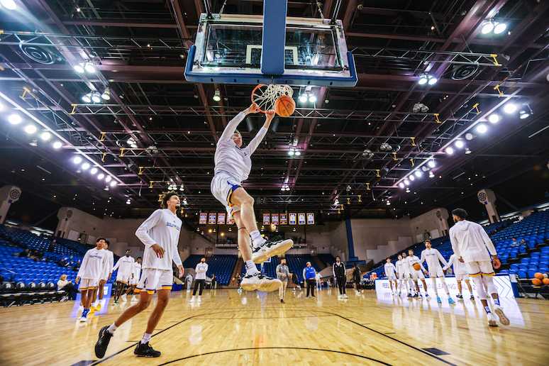 Photo by Kyle Tran | SJSU guard Garrett Anderson drops the ball into the net during pregame warm up Tuesday in the Provident Credit Union Center
