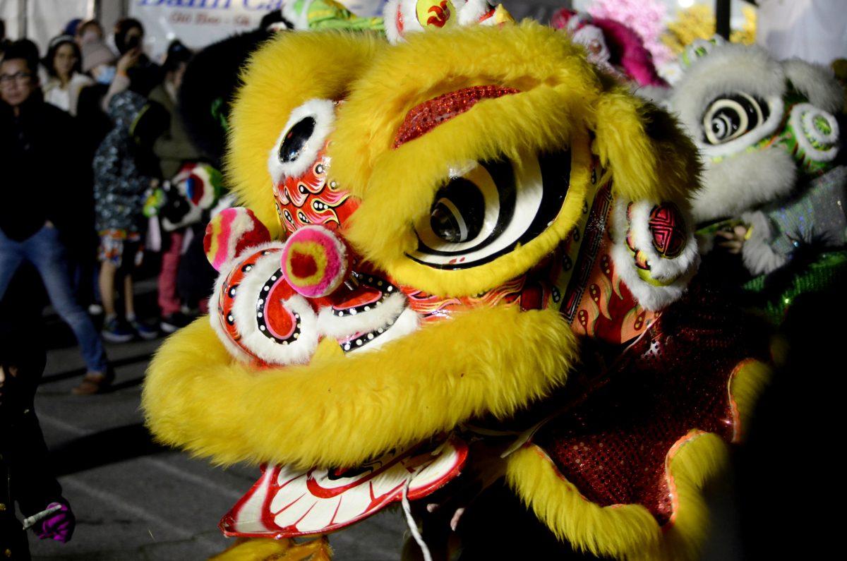 Middle: Festival participants performed the traditional Chinese Lion Dance at the center stage of the festival.
