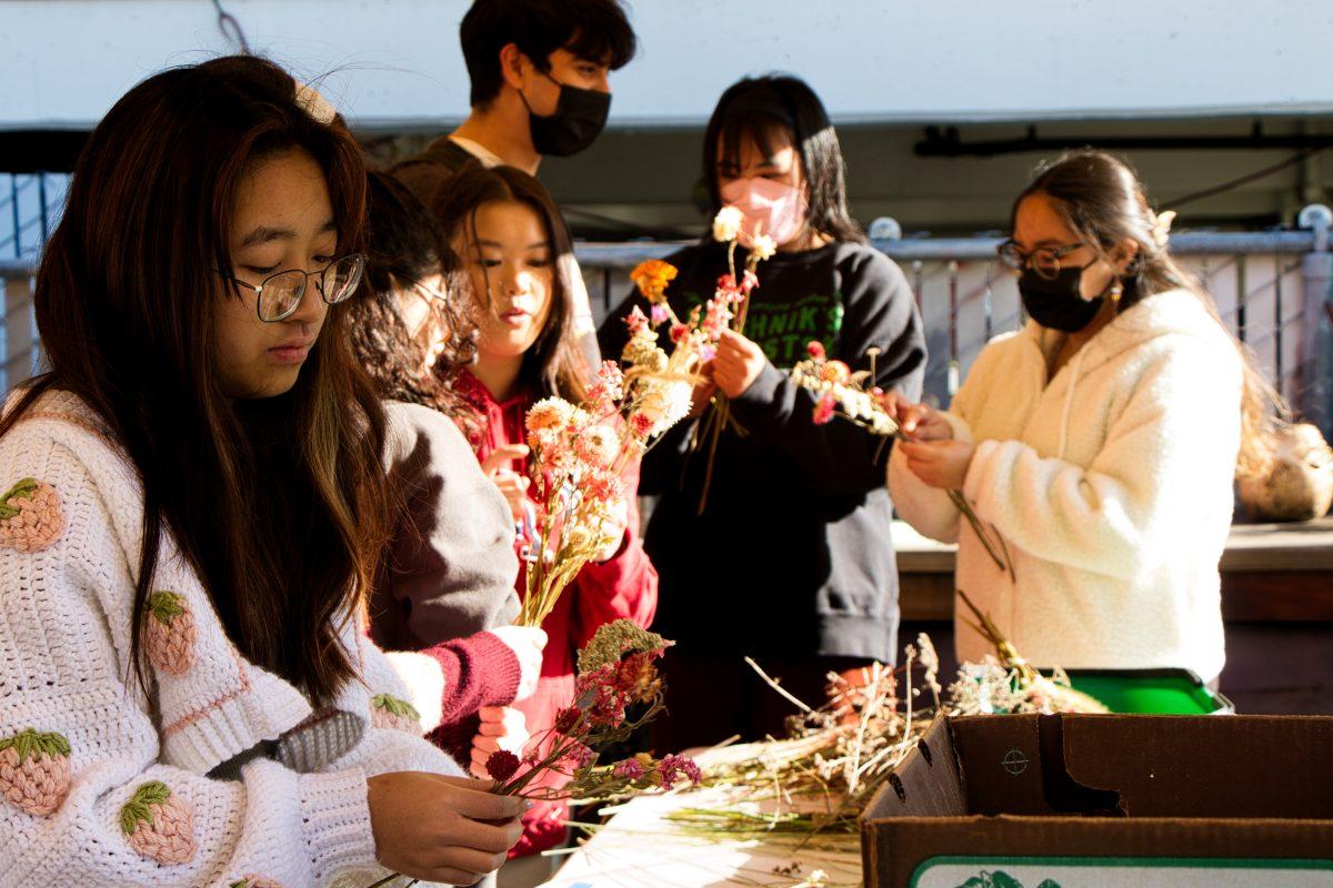 Students personalize their dried flower bouquets for Valentine&#8217;s Day at SJSU Community Garden.