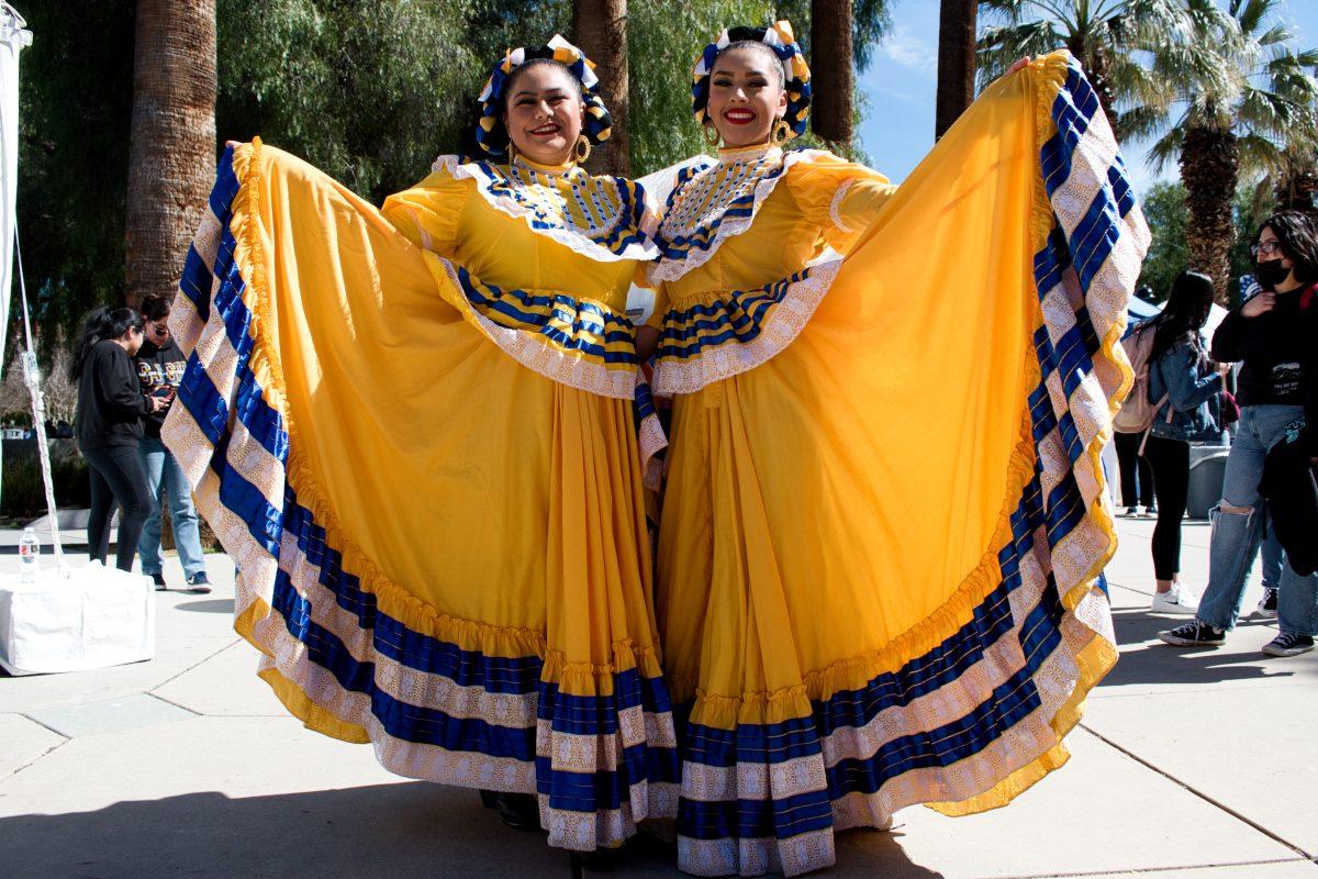 Pre-nursing freshman Julisa Ascencio Galvez and psychology freshman Vesenia Torres pose in their dresses before performing with their dance group Grupo Folkl&#243;rico Luna y Sol.