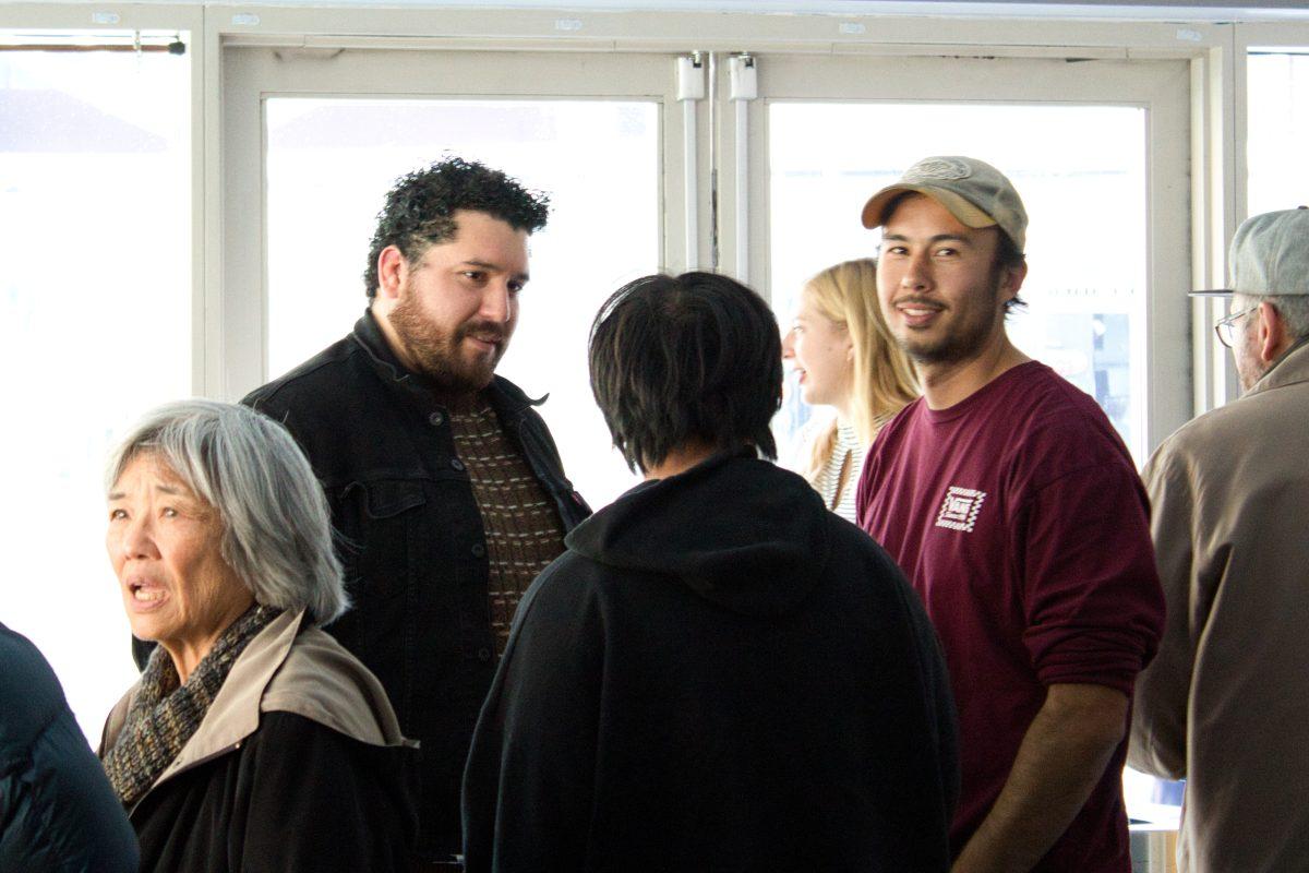 Darren Haruo Rae (right) talks with family members and friends after Nisei showings on Saturday at the Hammer Theatre Center.