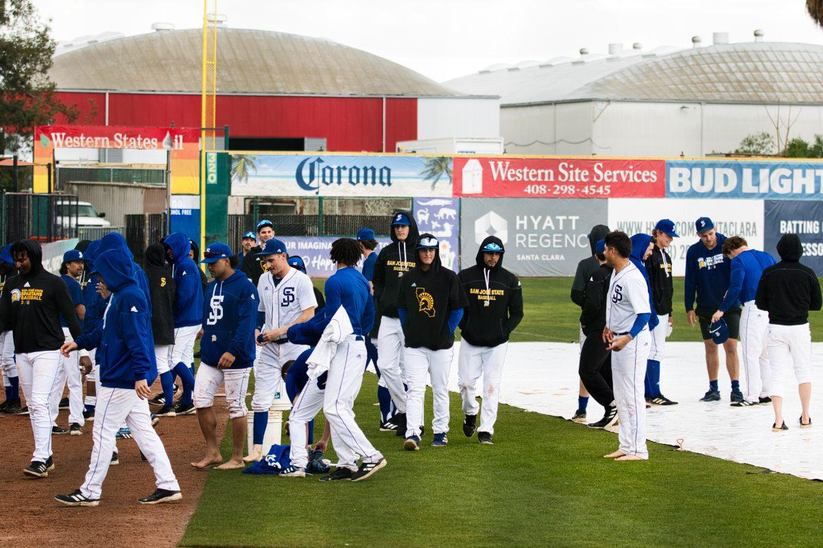 The SJSU baseball team walks off the field after its game was canceled on Sunday after heavy rain dampened the field.
