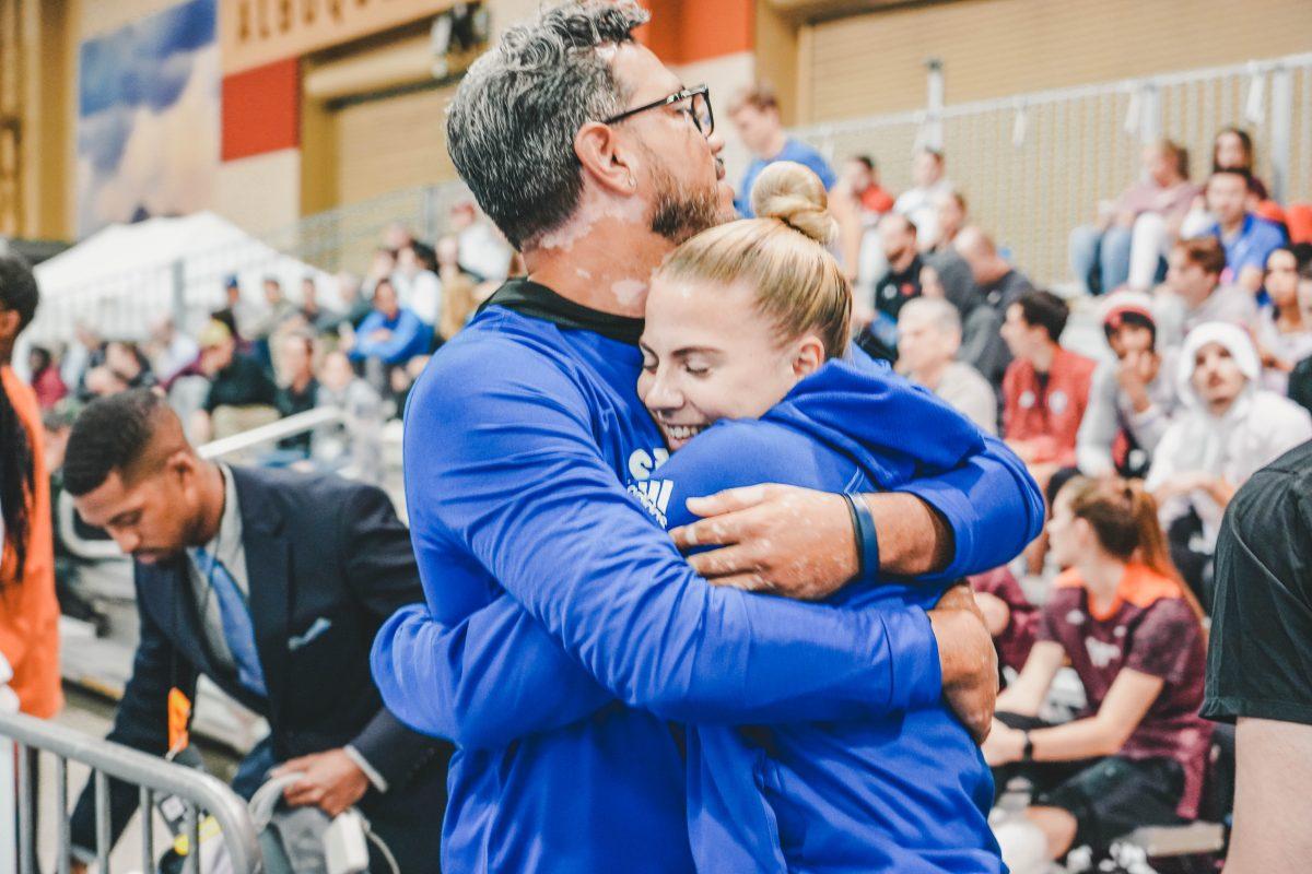 Emilia Sjostrand and Charles Ryan, director of track & field and cross country, embrace after Sjostrand was named an All-American at the NCAA Indoor Championships in Albuquerque, New Mexico. 