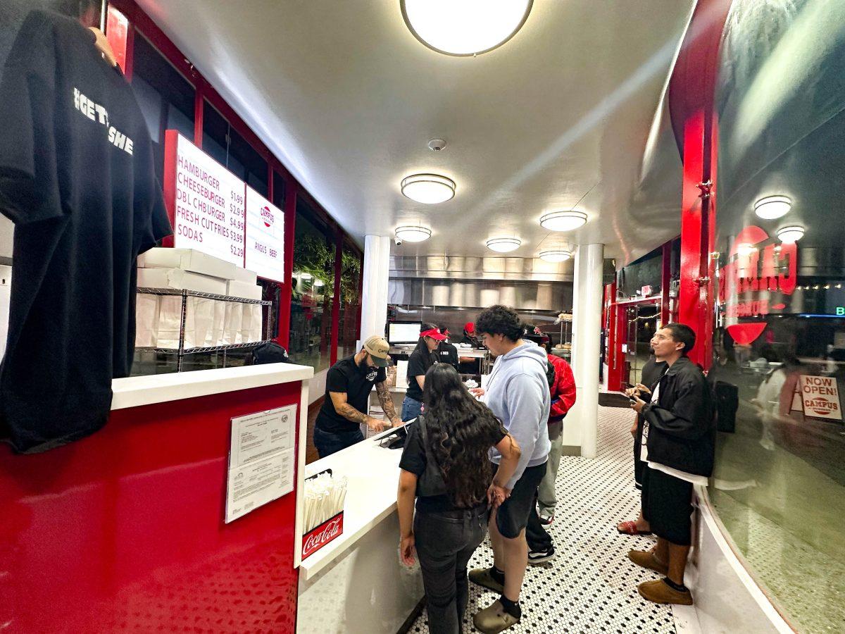 Customers line up inside to order food items off the menu, for between $2 to $5, at the newly opened Campus Burgers restaurant located in downtown San Jos&#233;. 
