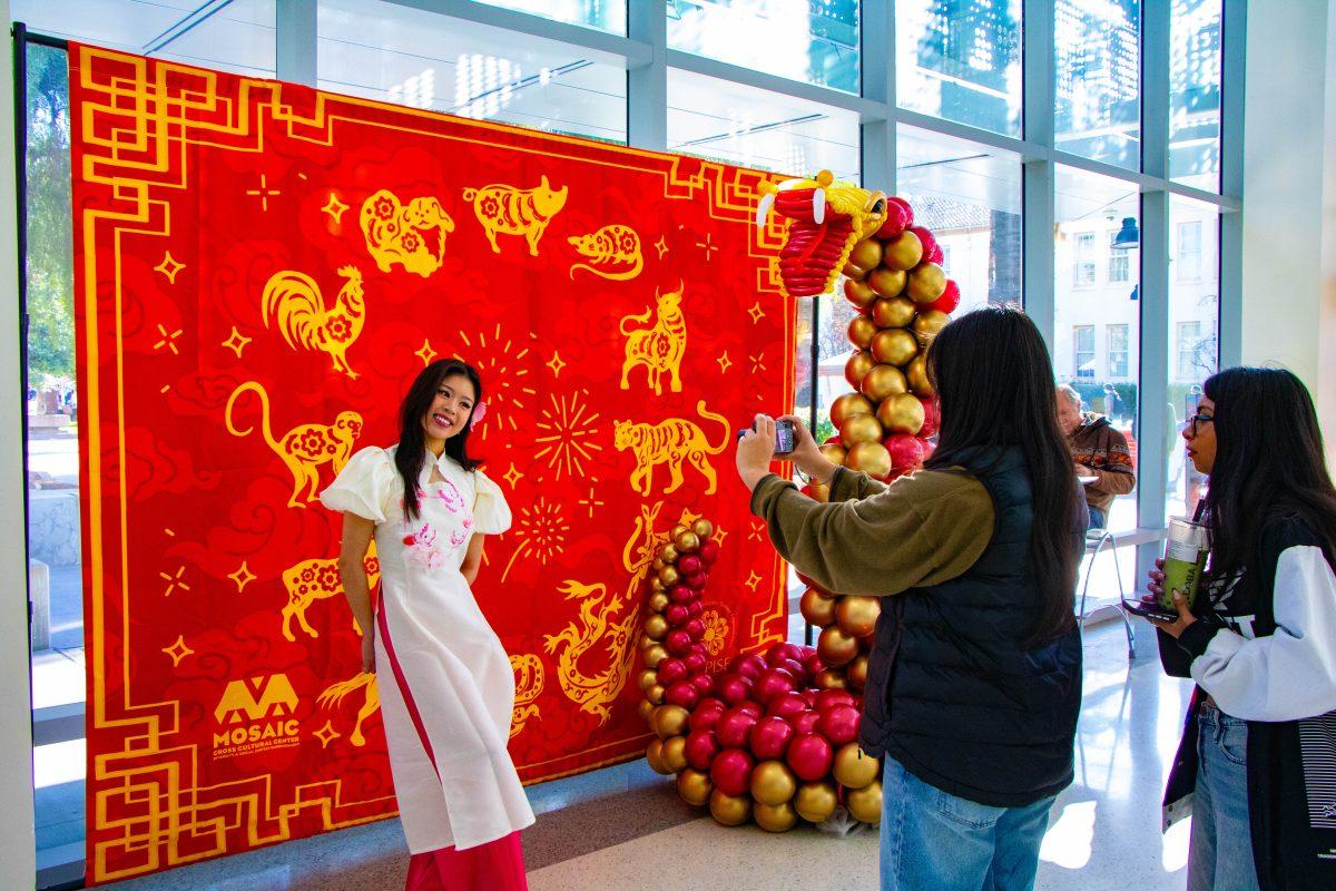 Alina Nguyen, business analytics student, poses as her friends take her picture in front of the twelve animals of the Chinese zodiac.