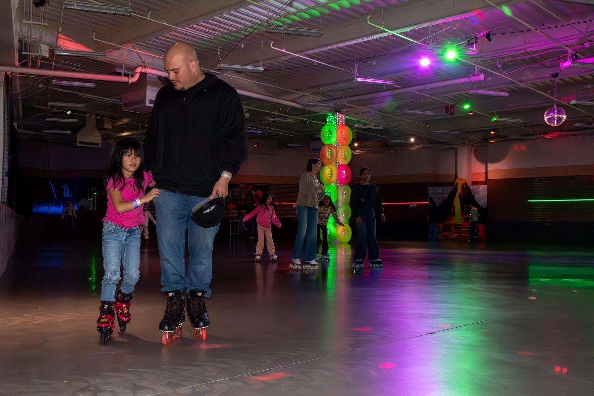 Arnold Monteon and his 6 year-old-daughter, Aubrianna, skate around in circles at the roller rink inside the Aloha Fun Center on Saturday.