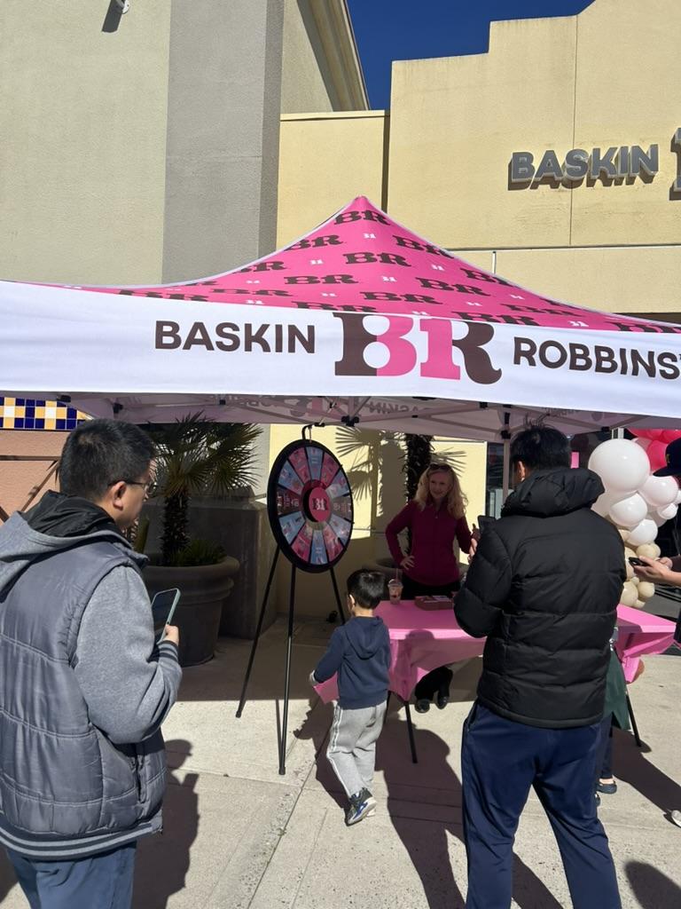 Community members celebrate the grand opening of the Camden Baskin-Robbins and line up to try and spin a wheel for the chance of free ice cream.