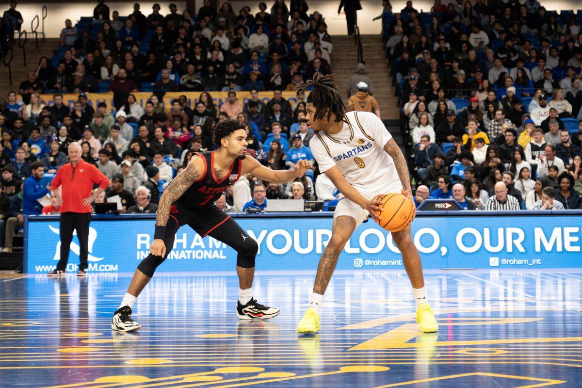 Guard Donavan Yap Jr. (0) scans the court during the Tuesday night game while San Diego State University guard Nick Boyd (2) attempts to guard him.