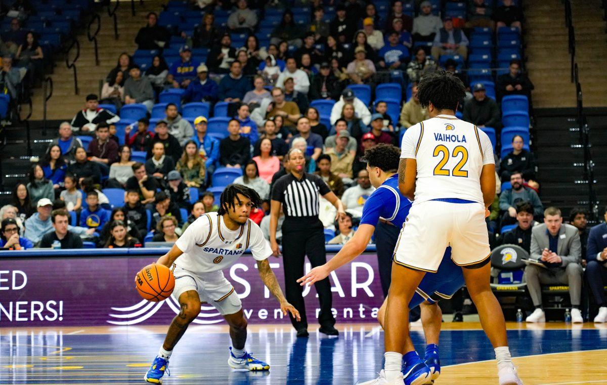 Graduate guard Donavan Yap (left) dribbles past defense with help from teammate Robert Vaihola (right).