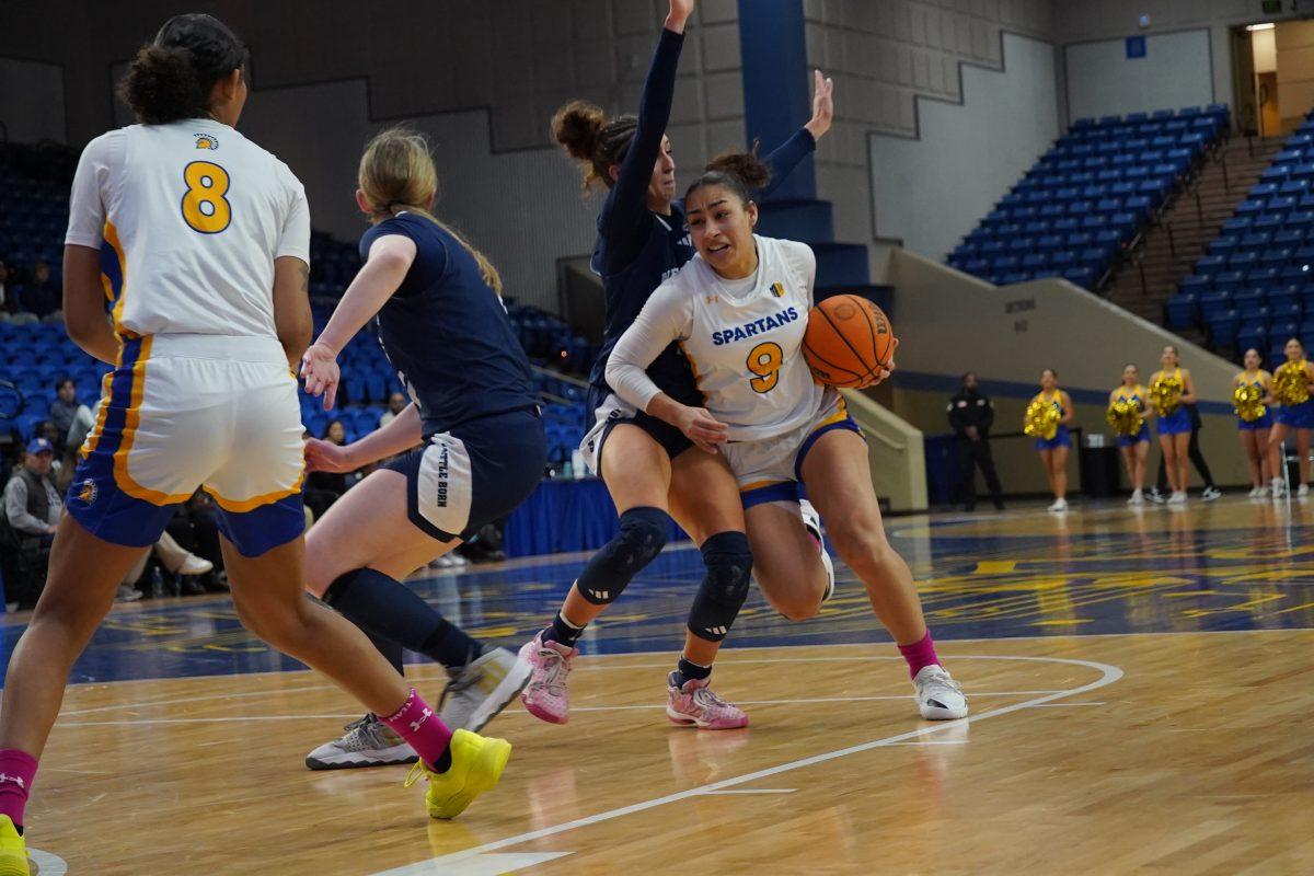 Rylei Waugh (9) dribbles and fi ghts off defenders, against Nevada during Saturday's game at the Provident Credit Union Event Center.
