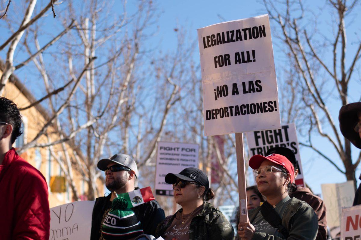 Protesters march in front of the Mexican Heritage Plaza holding numerous signs to show their support against Trump&#8217;s immigration policies on Sunday.