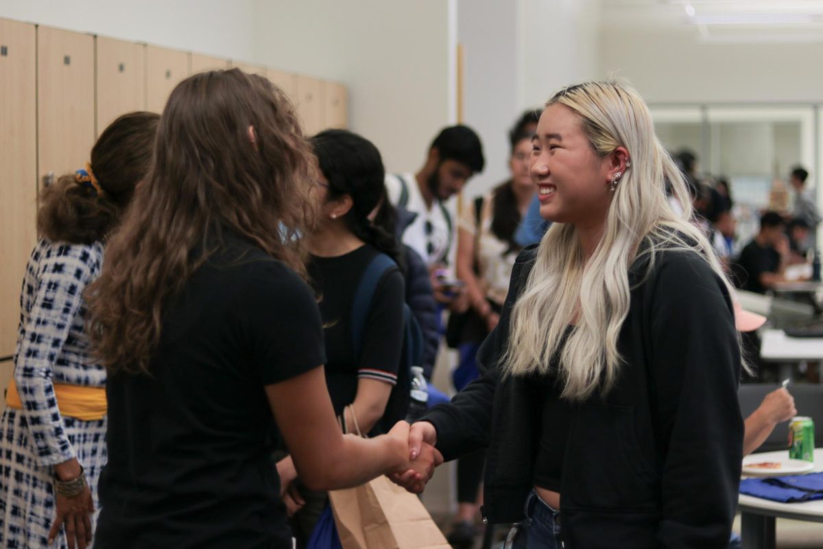 SJSU Associated Students President Katelyn Gambarin greets a student before grabbing food at the “Pizza with the Presidents” event in the Student Union.