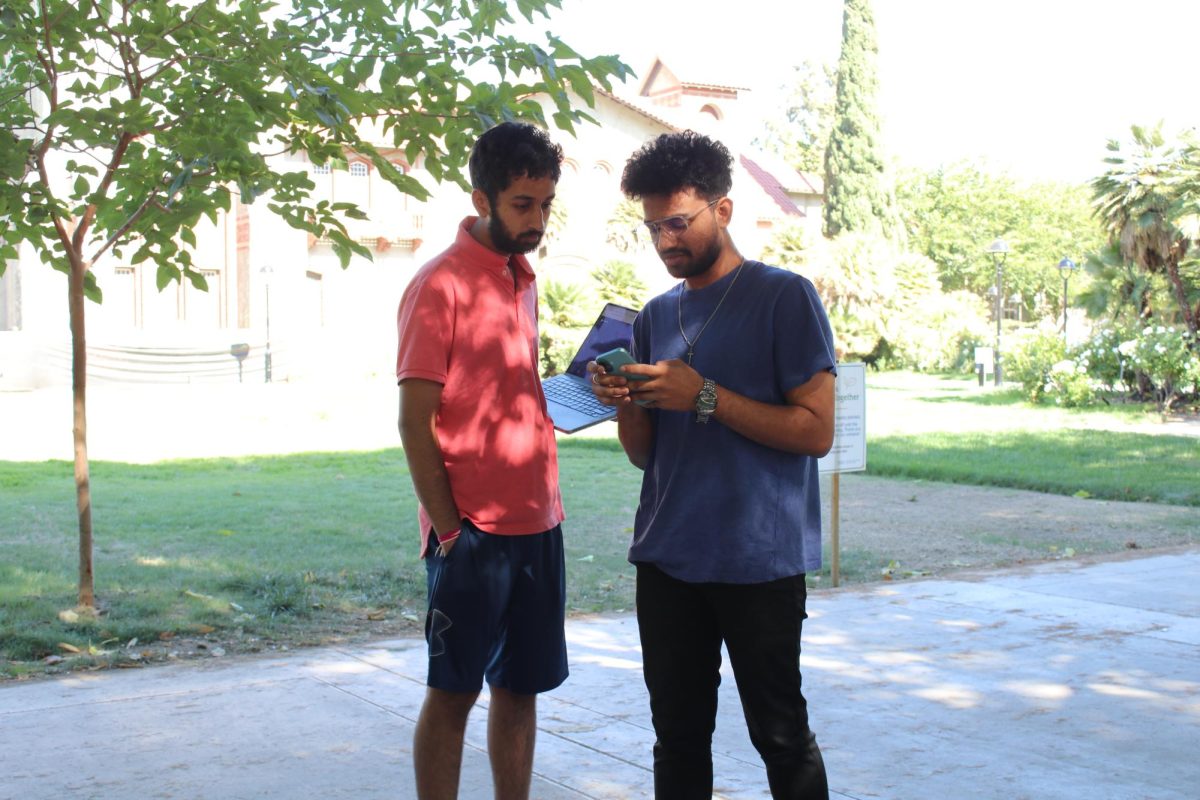 SJSU students Rohan Poosla, (left) and Issac Veerla, (right) discuss course work near Tower Lawn.