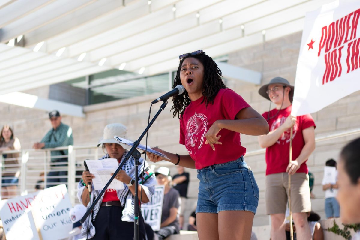 Orisa Coombs, president of the United Electrical Local 1043, Stanford Graduate Workers Union, speaks to rally attendees in front of San José City Hall.