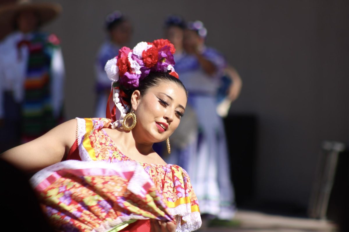 Dancer twirls and dances in front of the Provident Credit Union Event Center for the “Festival de la Independencia” on Tuesday afternoon.