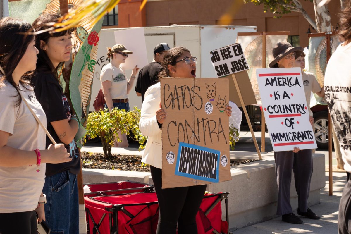 Brisa Moreno, chief of staﬀ for San José Councilmember Peter Ortiz, holds a sign protesting ICE operations on Sunday.