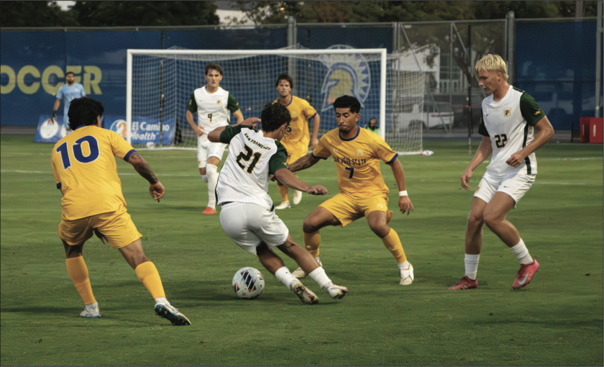 University of San Francisco junior Midfielder Kaleb Afsari attempts to dribble through San José State defenders.