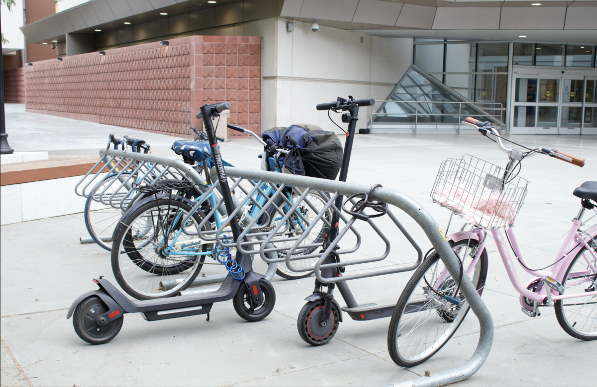 Several San José State University students keep their locked bikes and electronic scooters near the entrance of the Dr. Martin Luther King, Jr. Library on campus. 